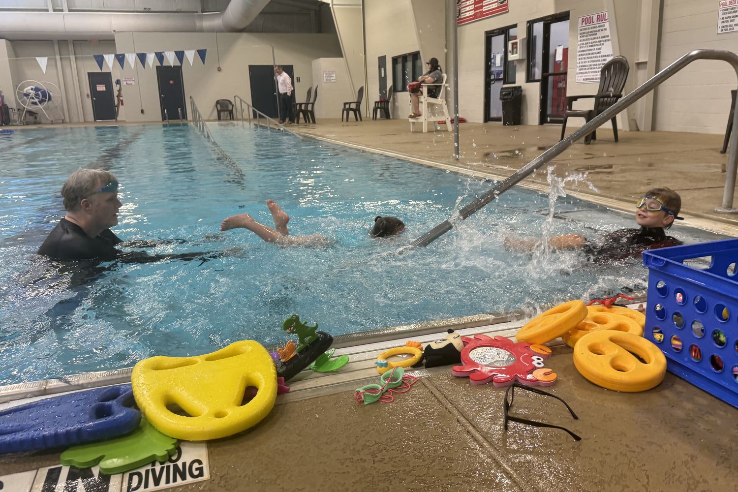Coach Jamey teaching two young swimmers at the Morgan County Aquatic Center in Madison